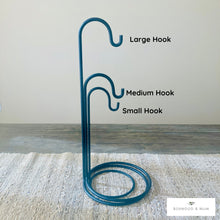 Load image into Gallery viewer, Metal hook stand with labeled large, medium, and small hooks on a neutral background.