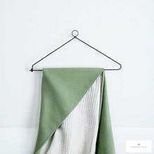 Load image into Gallery viewer, Green fabric art draped over a black wrought iron wall hanger against a white background