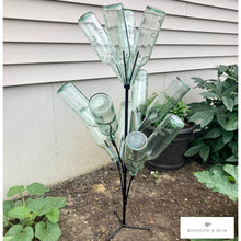Load image into Gallery viewer, Bottle tree stand shown in the garden surrounded by plants.  Holds 12 standard wine bottles.
