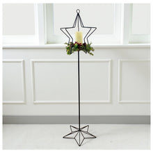Load image into Gallery viewer, Wrought Iron Tall Candle Stand Christmas Home Decor. Decorative black metal candle holder with star design against a white paneled wall.