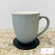 Load image into Gallery viewer, Black Thick Leather Coaster holding a coffee mug