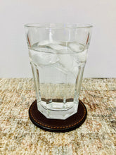 Load image into Gallery viewer, Dark Brown Leather Coaster holding a large glass of water.