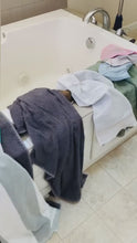Load and play video in Gallery viewer, video showing lots of towels laying all over the side of a bath tub and then a wall mount laundry rack is placed on the wall next to the tub and shows all the towels hanging up neatly and organized