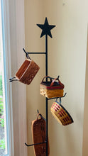 Load and play video in Gallery viewer, video of the basket floor stand starting at the top and moving down to the bottom.  The video shows the rustic star on top and the 8 hangers for baskets and the bottom base section which has 3 legs.