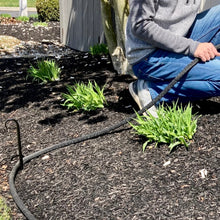 Load image into Gallery viewer, Watering Hose turning the corner around the bottom of the metal stake.