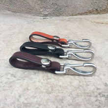 Load image into Gallery viewer, 3 colors of leather keychains including light brown, black and dark brown.  Keychains are made with heavy duty bridle leather and have a snap to open and close it around a belt or purse handle.
