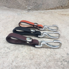 Load image into Gallery viewer, 3 colors of leather keychains including light brown, black and dark brown.  Keychains are made with heavy duty bridle leather and have a snap to open and close it around a belt or purse handle.