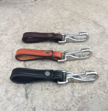 Load image into Gallery viewer, 3 leather keychains with stainless steel hardware pictured from the side.
