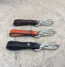 Load image into Gallery viewer, 3 leather keychains with stainless steel hardware pictured from the side.