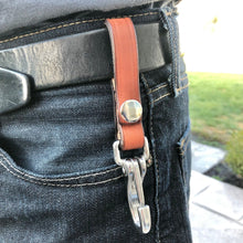 Load image into Gallery viewer, A light brown durable leather keyholder with a snap that is pictured on a man's belt.