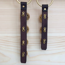 Load image into Gallery viewer, 2 sets of solid brass bell door hangers pictured from the back
