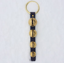 Load image into Gallery viewer, 4 solid brass bells attached to a dark brown leather strap with a brass plated ring door hanger