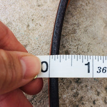 Load image into Gallery viewer, Picture measuring the belt leather thickness slightly less than a quarter of an inch
