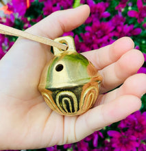 Load image into Gallery viewer, Solid Brass Bell with leather string in a child&#39;s hand
