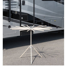 Load image into Gallery viewer, 16-arm wood drying rack set up in front of an RV