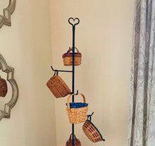 Load image into Gallery viewer, close up picture of the rustic heart shape at the top of the wrought iron basket floor stand.