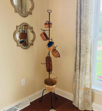 Load image into Gallery viewer, rustic basket holder pictured inside holding baskets.  Basket stand is made of wrought iron.  This basket stand has a rustic star at the top.