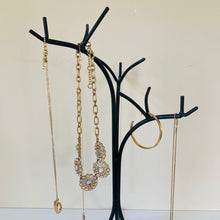 Load image into Gallery viewer, Close up of the jewelry tree organizer showing the 3 main branches holding several jewelry pieces.