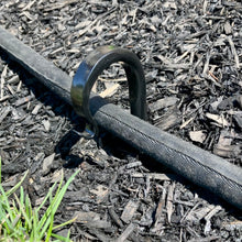Load image into Gallery viewer, Hose running through a hose guide hook that pushed low in the ground.  Length of garden hooks is 17.75 inches which allows you to adjust the height of the stake in the ground.