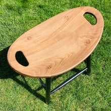 Load image into Gallery viewer, Top angle of saddle stool with a special walnut stained seat.
