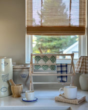 Load image into Gallery viewer, Mini drying rack for counter or table top pictured in a kitchen holding small tea towels
