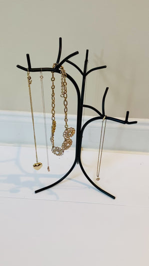 video showing the different angles of the wrought iron jewelry stand