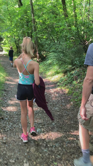 hiker bell ringing as family hikes through woods