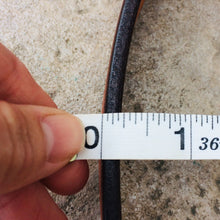 Load image into Gallery viewer, Picture measuring the belt leather thickness slightly less than a quarter of an inch
