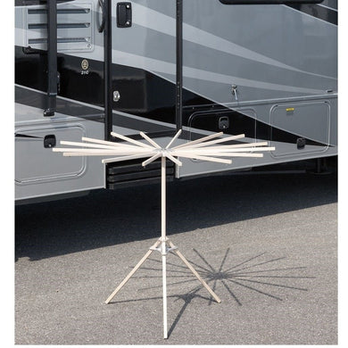 16-arm wood drying rack set up in front of an RV