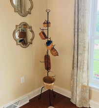Load image into Gallery viewer, rustic basket holder pictured inside holding baskets.  Basket stand is made of wrought iron.  This basket stand has a rustic star at the top.
