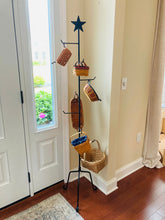 Load image into Gallery viewer, rustic star basket stand rack in the corner of a foyer next to a window.  Basket stand has 8 hangers to hang baskets. 
