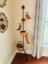 Load image into Gallery viewer, Rustic star basket stand in the corner of a living room holding 6 baskets.
