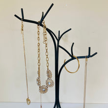 Load image into Gallery viewer, Close up of the jewelry tree organizer showing the 3 main branches holding several jewelry pieces.
