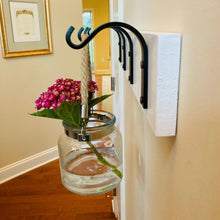 Load image into Gallery viewer, Side view angle of the medium sized metal wall hook.  
