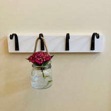 Load image into Gallery viewer, Front view of 4 rustic wall hooks mounted to a white board with a hanging mason jar with a pink hydrangea flower hanging from one of the hooks.  Hook only are for sale.  Mounting boards, screws and decorative items are not included with hooks.
