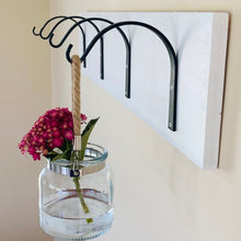 Load image into Gallery viewer, Boxwood &amp; Mum arched wall hanger hooks.  Wrought iron hooks shown from the side view hanging from a wall and mounted to a white board.  Mounting boards and screws are not included.  Each hook requires two screws.
