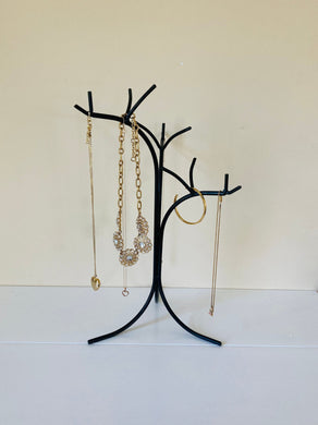 Hand Forged Wrought Iron Jewelry Tree holding several necklaces.
