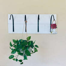 Load image into Gallery viewer, Farmhouse hooks size large shown from the front view and mounted to a white board.  Large hooks are holding a large planter and a hanging jar that contains a pink hydrangea.
